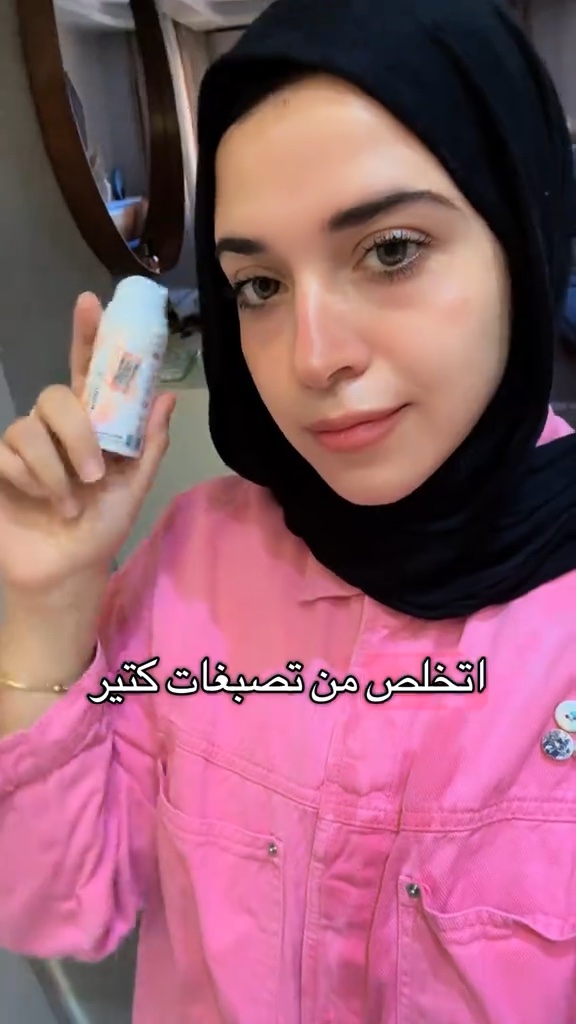 Dr. Soso holding an Altesse skincare bottle
